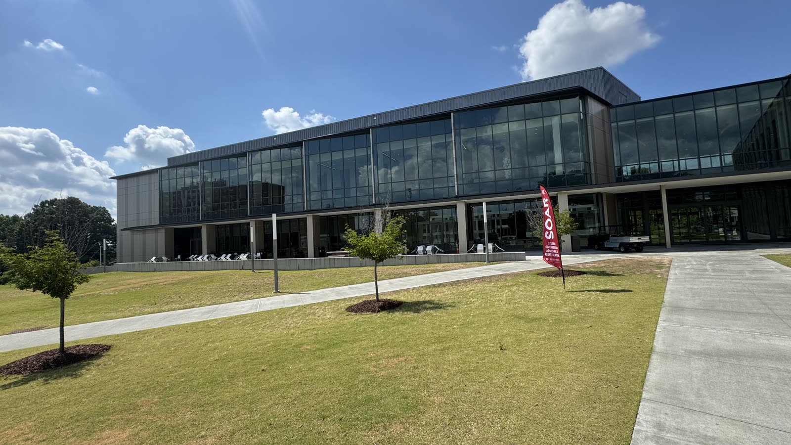 Exterior of the NCCU Student Center, a modern glass building on a green lawn